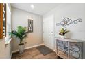 Inviting foyer with decor, light wood floors, and a light-filled window near the front door at 4412 Reding Way, Lakeland, FL 33813