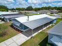 An aerial view of the home with a covered carport, showcasing its roof and surrounding neighborhood at 5015 Fox Cliff Dr, Lakeland, FL 33810