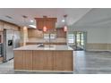 Modern kitchen featuring a central island, stainless steel appliances, and stylish pendant lighting at 5015 Fox Cliff Dr, Lakeland, FL 33810