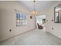 Open dining room showcasing neutral walls and plush carpet, perfect for entertaining or Gathering meals at 537 Eagle Run, Lakeland, FL 33809