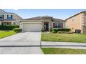 Well-maintained house with a two-car garage and professionally landscaped front yard at 5793 Dornich Dr, Auburndale, FL 33823