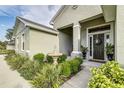 Close-up of home's entry featuring a fountain and lush landscaping at 6372 English Creek Dr, Lakeland, FL 33811