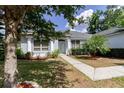 Inviting single-story home with elegant columns, lush landscaping, and a welcoming front entrance at 6626 Royal Forest Dr, Lakeland, FL 33811