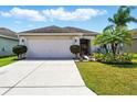 Well-maintained home with a two-car garage and manicured lawn at 7139 Cedarcrest Blvd, Lakeland, FL 33810