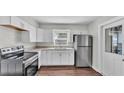 Modern kitchen featuring stainless steel appliances, white cabinets, and granite countertops at 747 E Bella Vista St, Lakeland, FL 33805