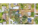 Aerial view showing the property lines, home, detached garage, and surrounding neighborhood at 828 E Valencia St, Lakeland, FL 33805