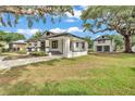 Charming home with a covered front porch, attached carport, and detached two-story garage at 828 E Valencia St, Lakeland, FL 33805