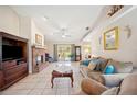 Comfortable living room featuring a brick fireplace and neutral decor at 8337 Fussell Rd, Polk City, FL 33868