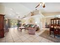 Inviting living room with vaulted ceilings, brick fireplace, and French doors at 8337 Fussell Rd, Polk City, FL 33868