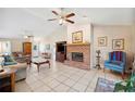 Spacious living room with brick fireplace, ceiling fan and comfortable seating arrangement at 8337 Fussell Rd, Polk City, FL 33868