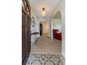 Bright entryway with light wood floors, decorative light fixture, and open floor plan at 1503 Clairdale Ln, Lakeland, FL 33801