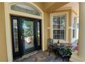 Charming front porch with decorative glass door and a small seating area at 1167 Stoney Creek Blvd, Lakeland, FL 33811