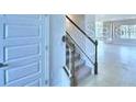 Elegant staircase with white trim and black railings at 2307 Brassie Ct, Winter Haven, FL 33884