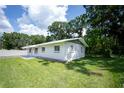 Charming single-story home featuring a well-maintained lawn and mature trees at 2527 Dons Pl, Lakeland, FL 33801