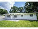 Cozy single-story home boasts a welcoming front yard and freshly painted grey exterior at 2527 Dons Pl, Lakeland, FL 33801