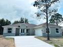 New construction home featuring stone accents, neutral colors, and an attached two car garage at 505 Shanklin Ave, Bartow, FL 33830