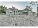 Single-Gathering home featuring a freshly painted exterior, an attached garage, and a raw landscape at 505 Shanklin Ave, Bartow, FL 33830