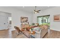 Stylish living room showcasing wood floors, comfortable seating, modern decor, and a seamless indoor-outdoor flow at 505 Shanklin Ave, Bartow, FL 33830