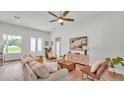 Bright living room featuring wood floors, neutral paint, stylish furniture, and French doors to the exterior at 505 Shanklin Ave, Bartow, FL 33830