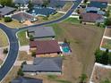 Aerial view of homes in a suburban neighborhood, featuring a house with a screened pool at 5612 Vintage View Blvd, Lakeland, FL 33812
