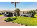 Charming single-story home with a pristine lawn, carport, and tropical landscaping at 610 Cottage Ln, Lakeland, FL 33803