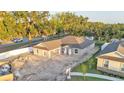 An aerial view showcasing a single-story home with a two-car garage in a landscaped setting at 803 Allison Place, Bartow, FL 33830