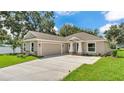Attractive single-Gathering home with a spacious driveway leading to a two-car garage, and stone facade accents at 803 Allison Place, Bartow, FL 33830