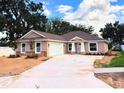 Charming single-story home featuring a neutral color scheme, attached two-car garage, and a well-manicured front yard at 803 Allison Place, Bartow, FL 33830