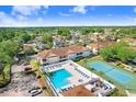 Aerial view of the community pool and tennis courts surrounded by residences at 8838 Coral Palms Ct # A, Kissimmee, FL 34747