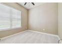 Cozy bedroom with soft carpet, a window with blinds, and neutral wall color at 1049 Stoney Creek Dr, Lakeland, FL 33811