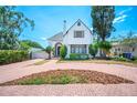 Charming two-story home with a red brick circular driveway and landscaped front yard at 112 Hiawatha Trl, Lakeland, FL 33803