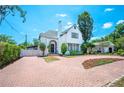 Charming two-story home with a red brick circular driveway and landscaped front yard at 112 Hiawatha Trl, Lakeland, FL 33803