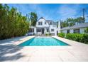 Backyard swimming pool with stone patio, perfect for outdoor entertaining at 112 Hiawatha Trl, Lakeland, FL 33803