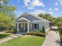 Well-maintained single-Gathering home with a manicured lawn, a cozy front porch and a paved walkway at 117 Palmola St, Lakeland, FL 33803