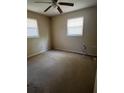 Empty bedroom featuring neutral walls, carpet, and two windows allowing ample natural light at 1226 N Brunnell Pkwy, Lakeland, FL 33805