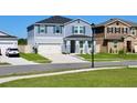 Well-maintained two-story home showcasing a two-car garage and inviting front yard at 1280 Denali Dr, Winter Haven, FL 33880