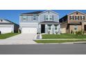 Beautiful two-story home with a two-car garage, featuring a well-kept lawn and tidy landscaping at 1280 Denali Dr, Winter Haven, FL 33880