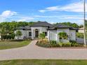 Beautiful white home with manicured lawn and a metal roof, perfect for curb appeal at 13137 Lake Butler Blvd, Windermere, FL 34786