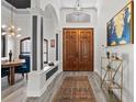 Elegant entryway featuring wood floors, arched doorways, and a stylish light fixture at 13137 Lake Butler Blvd, Windermere, FL 34786