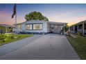 Charming single-story home featuring a covered carport, well-maintained lawn, and tasteful landscaping at 1506 Longbow Dr, Lakeland, FL 33810