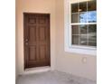 Inviting entryway featuring a new, dark-stained front door with side window, allowing ample natural light at 1890 Martin Luther King, Jr. E Blvd, Bartow, FL 33830