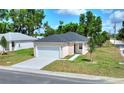 Single-story home boasts a freshly laid lawn, new driveway, and charming facade with a two-car garage at 1890 Martin Luther King, Jr. E Blvd, Bartow, FL 33830
