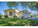 Beautiful one-story home featuring a manicured lawn, garden beds, and attached two-car garage at 217 Dillon Way, Davenport, FL 33897