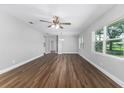 Bright living room featuring hardwood floors, a modern ceiling fan, and natural light at 2400 Avenue D Sw, Winter Haven, FL 33880