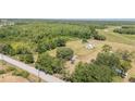 An aerial view shows the home's placement among lush greenery in a rural setting at 3728 Old Polk City Rd, Lakeland, FL 33809