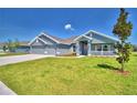 Beautiful single-story home features a three-car garage and a well-manicured lawn with landscaping at 4027 Tullamore Ln, Auburndale, FL 33823