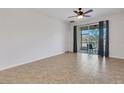 Spacious bedroom featuring tile floors, ceiling fan and sliding glass doors to lanai at 4089 Shade Tree Ln, Lakeland, FL 33812
