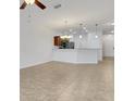 Open concept living and kitchen area with tile flooring and lots of natural light at 4089 Shade Tree Ln, Lakeland, FL 33812