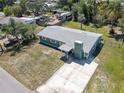 Aerial view of a charming one-story home with a well-maintained yard and a long concrete driveway at 4830 Melody Ln, Lakeland, FL 33805
