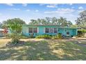 Charming single-story home with lush landscaping, flowerbeds, and a well-manicured lawn at 503 Carolyn Dr, Lakeland, FL 33803